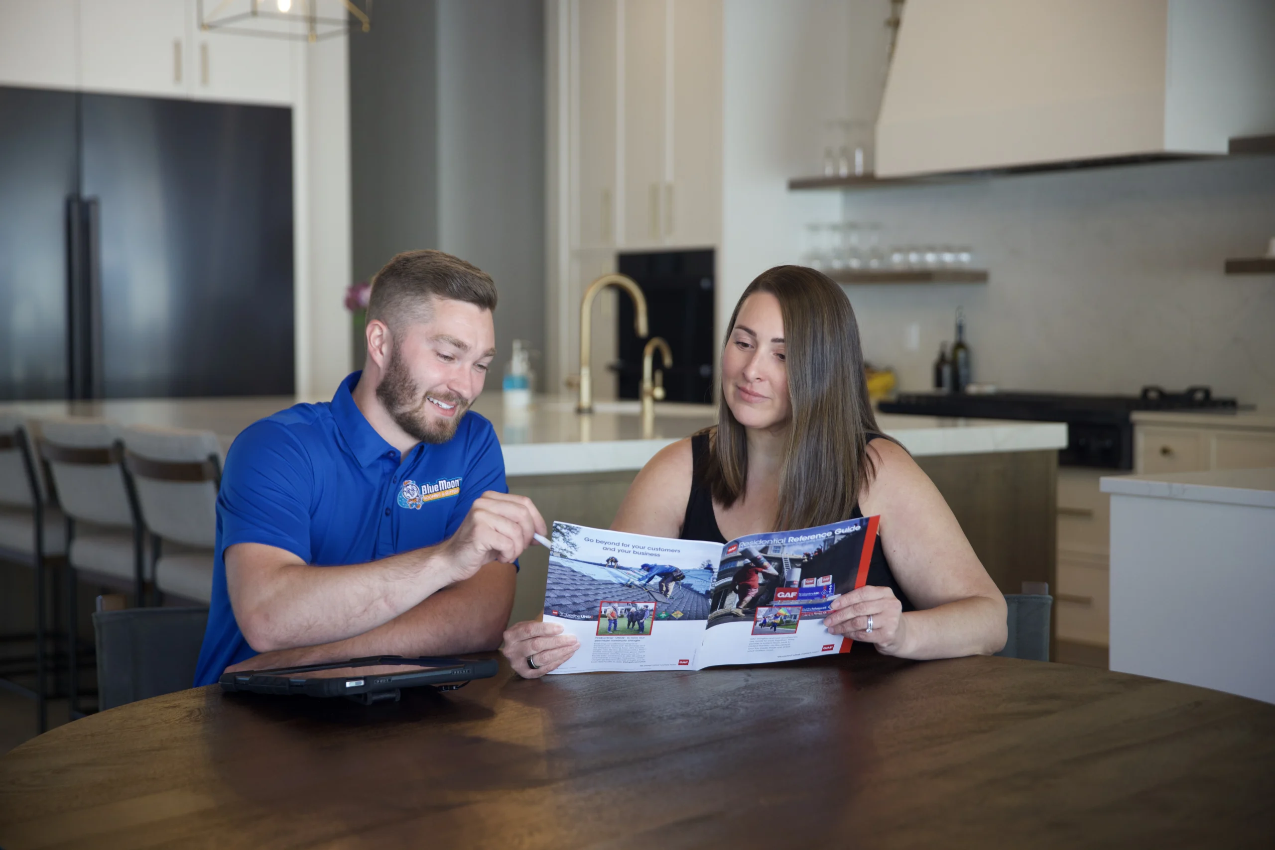 Man showing a woman blue moon roof's catelog