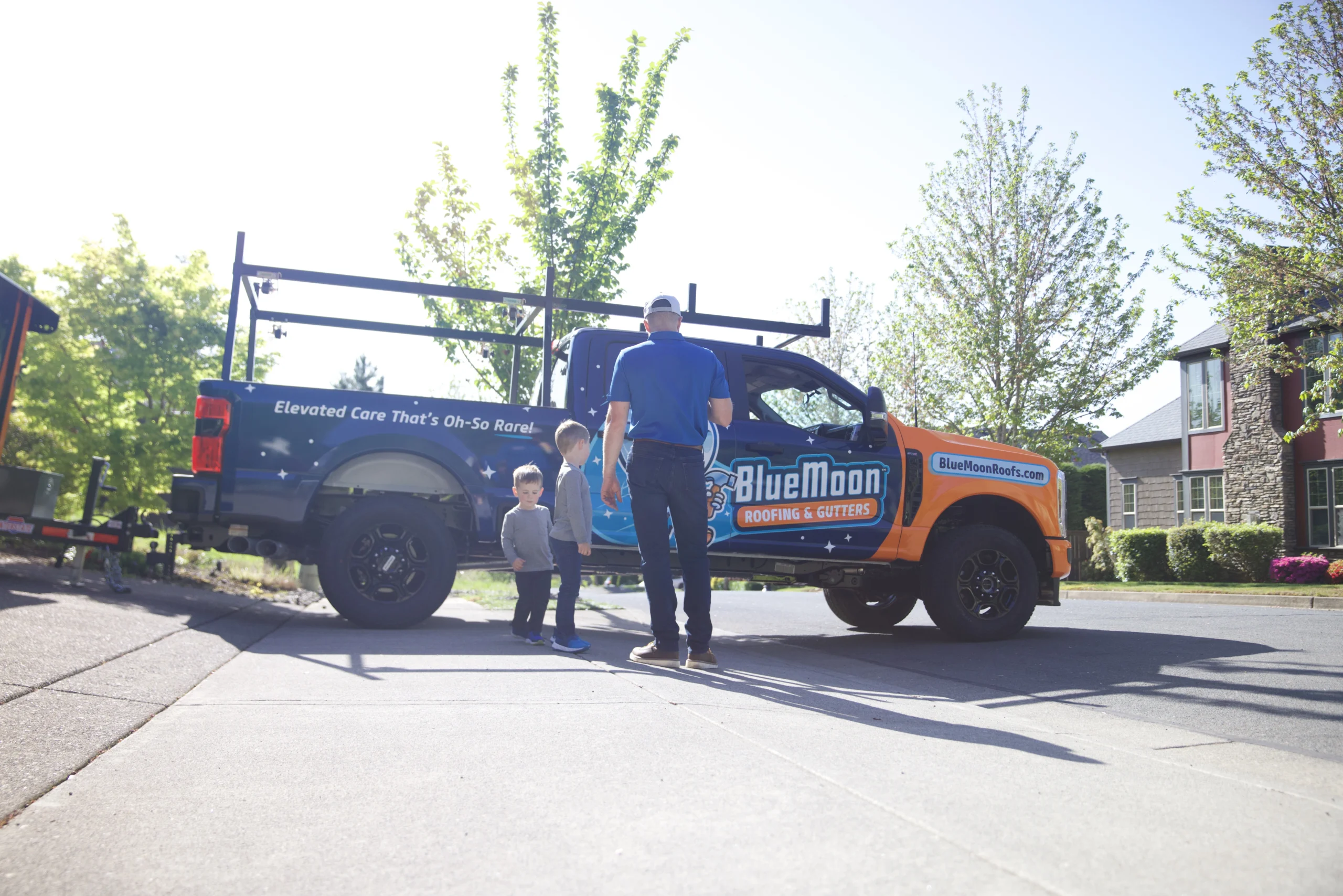 Man standing in front of his Blue Moon Roofs truck.